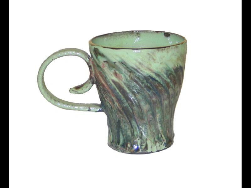 A green mug with a handle on the side.