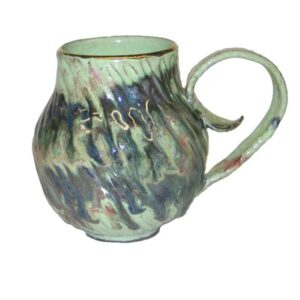 A green mug with some blue and brown swirls