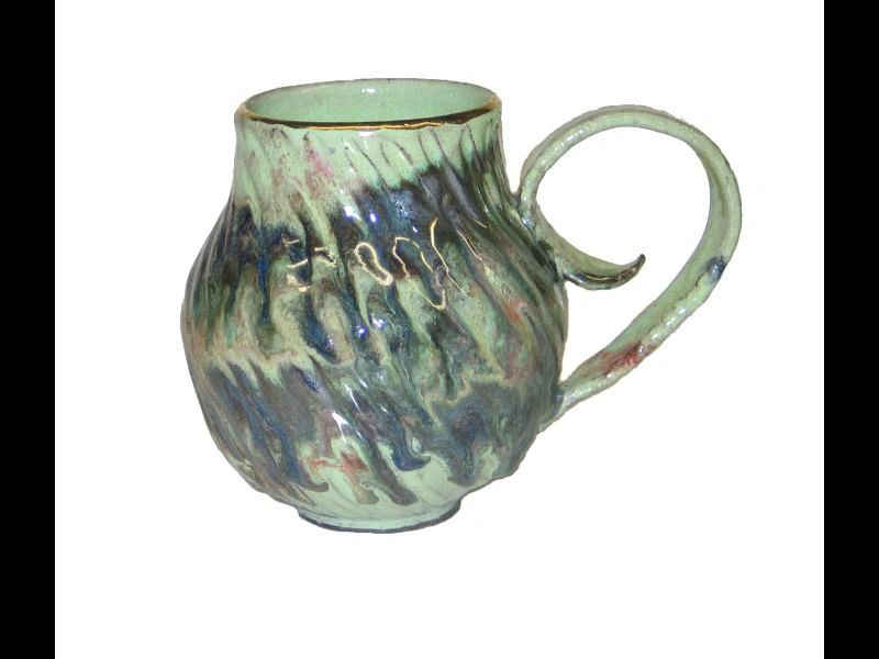 A green mug with some blue and brown swirls