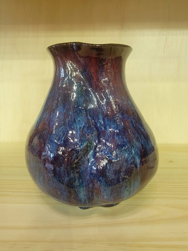 A blue and red vase sitting on top of a table.