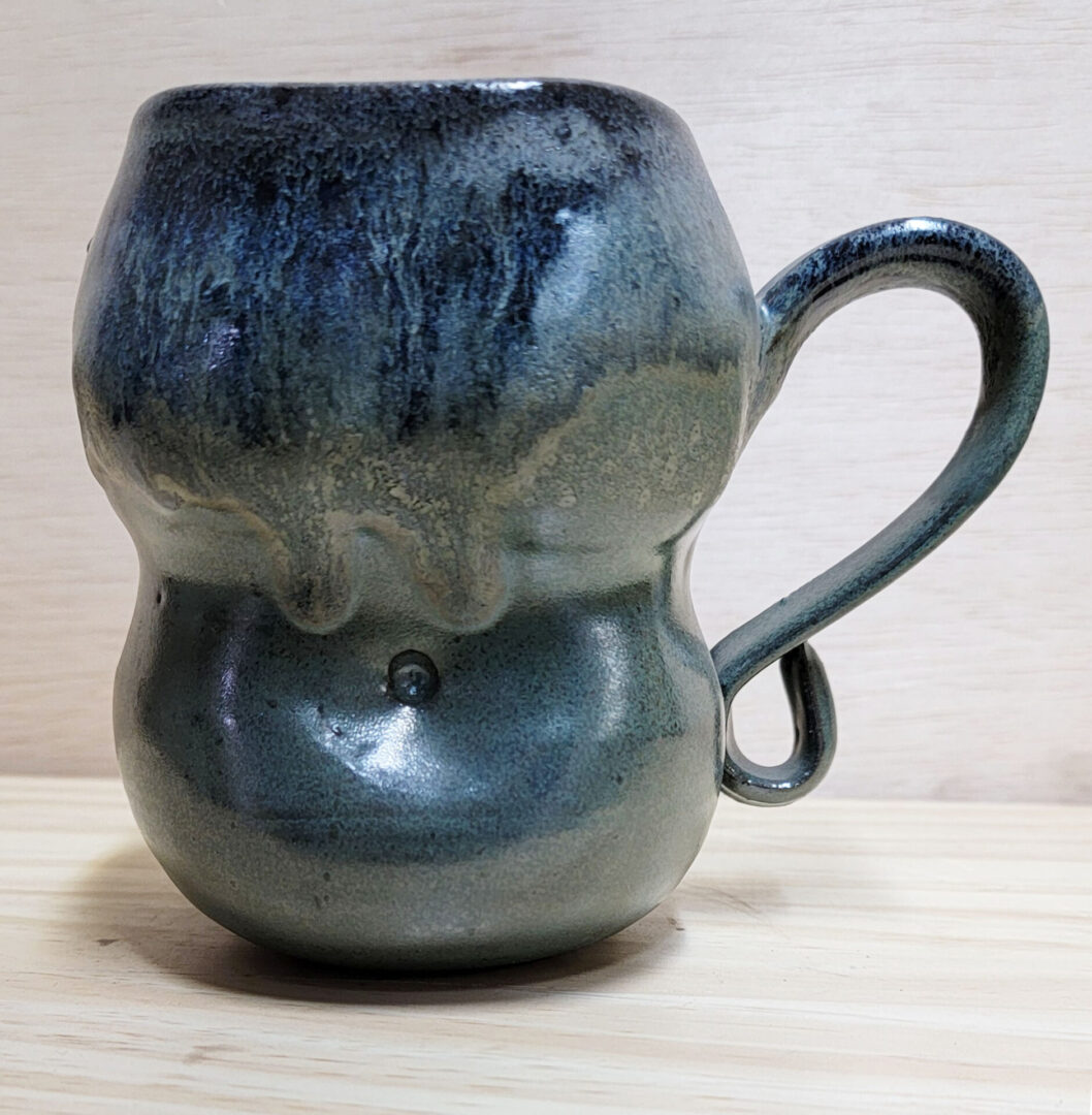 A mug that is shaped like an elephant.