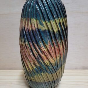 A vase with many colors on it