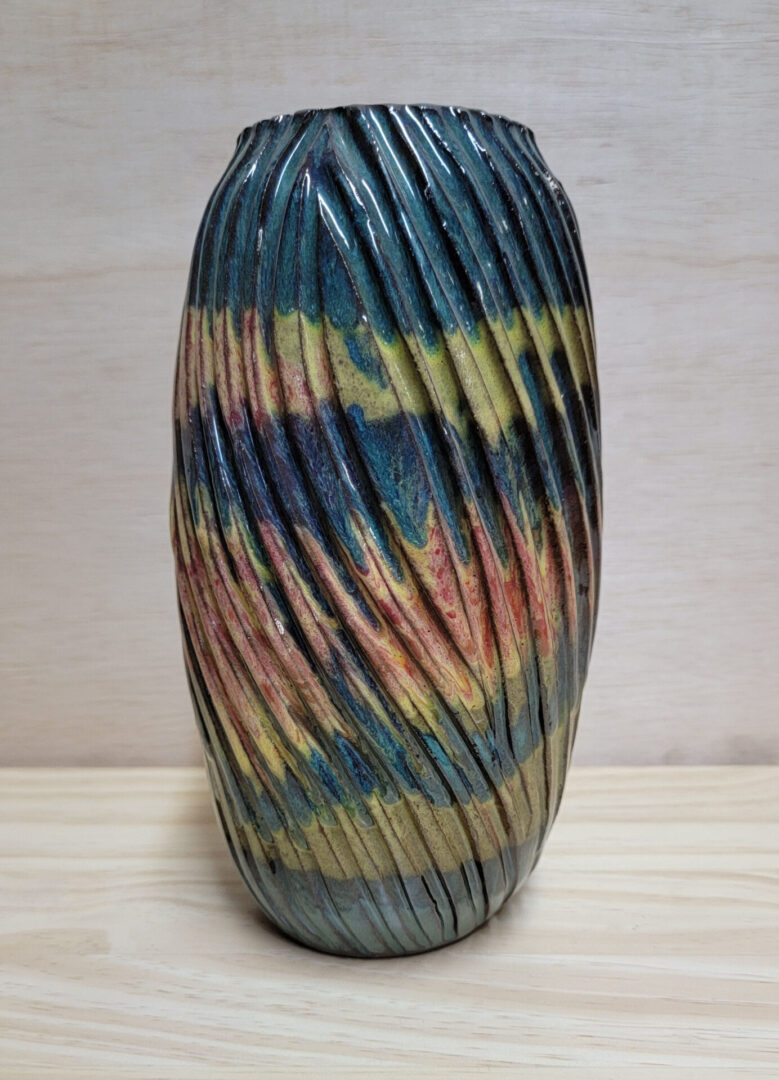 A vase with many colors on it