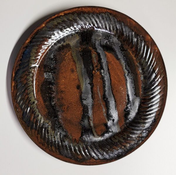 A brown plate with black and white stripes on it