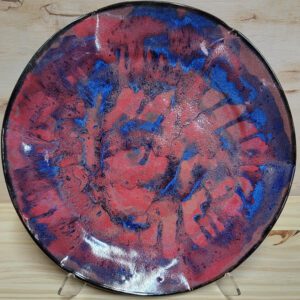 A plate with red and blue paint on it