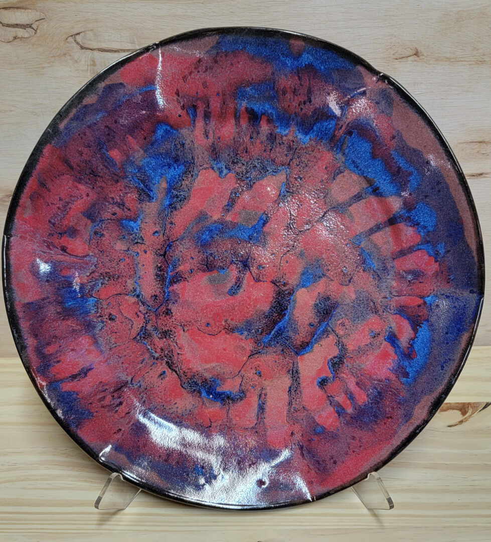 A plate with red and blue paint on it