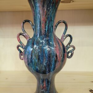 A blue vase with two handles on top of a table.