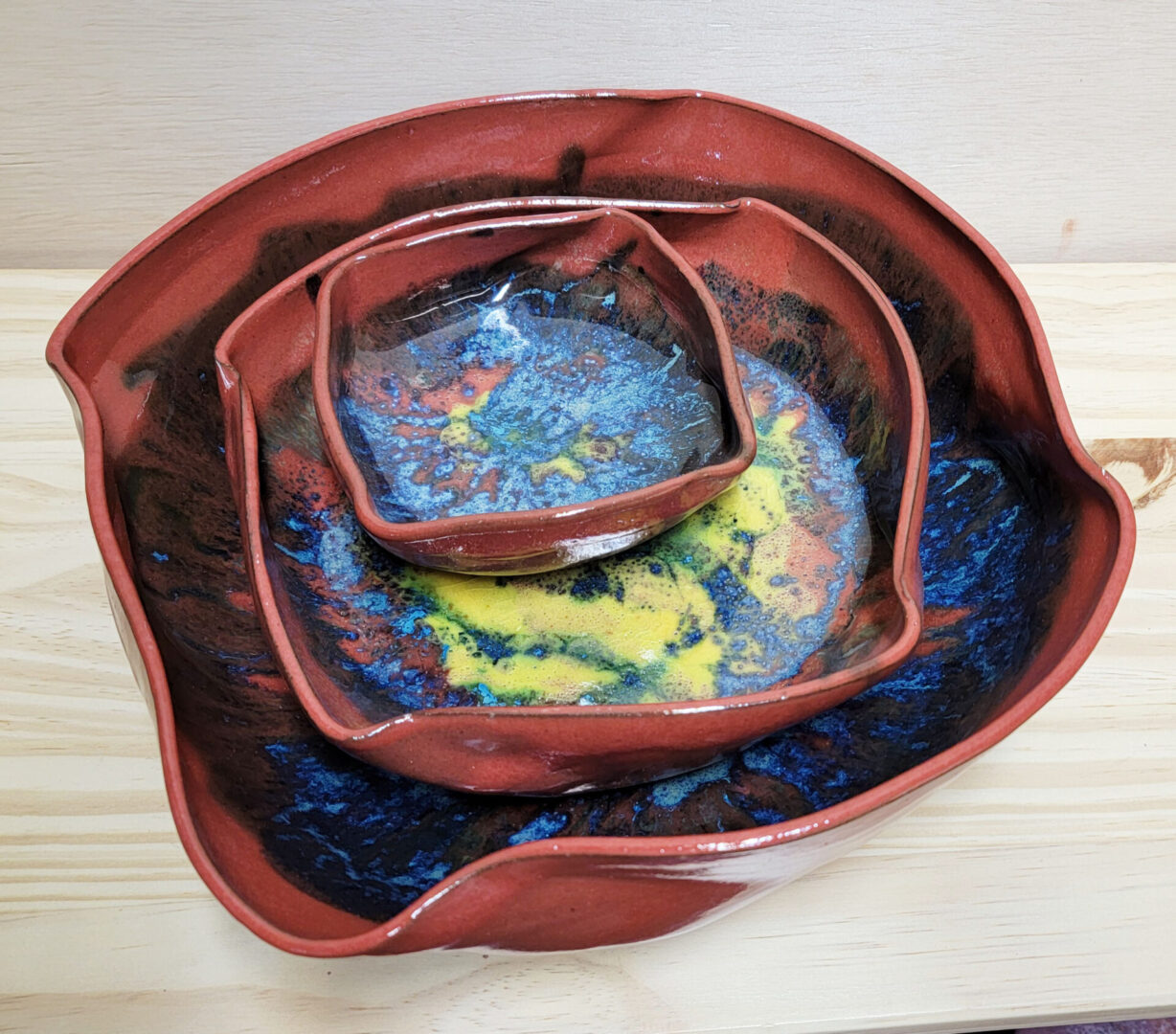 A set of three bowls with different designs on them.