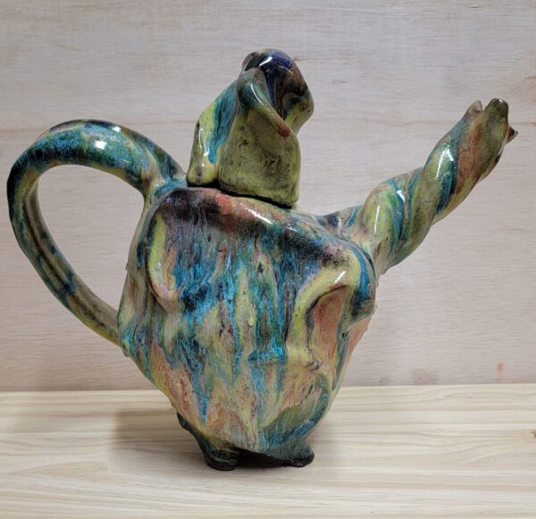 A ceramic teapot with a blue and green glaze.