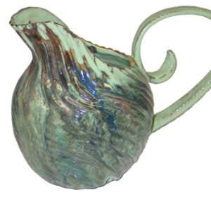 A green pitcher with a swirl handle.