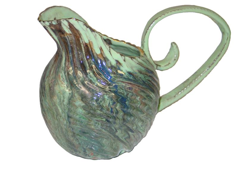 A green pitcher with a swirl handle.