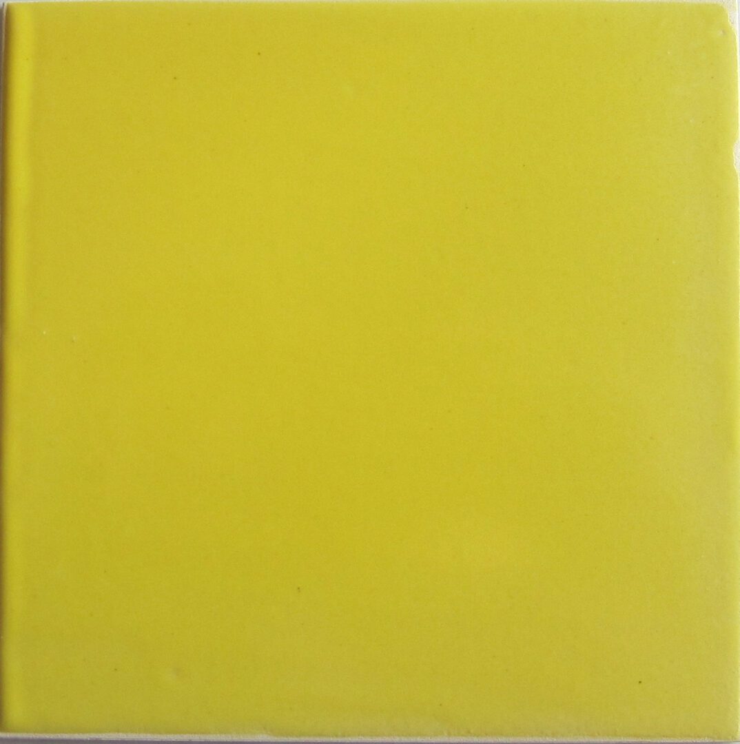 A yellow tile with some white lines on it