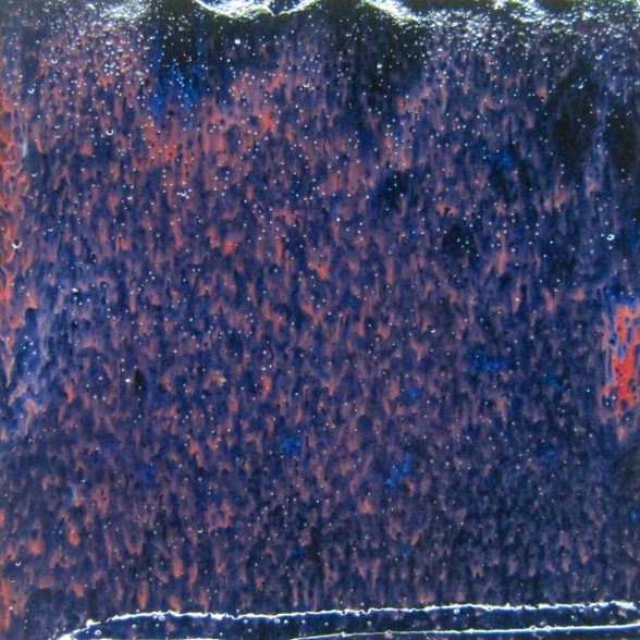 A close up of the surface of a blue and red painting