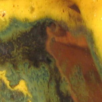 A close up of the rust on a yellow and green surface.