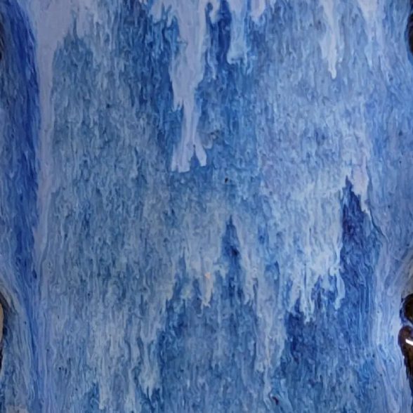 A blue waterfall with water flowing down it.